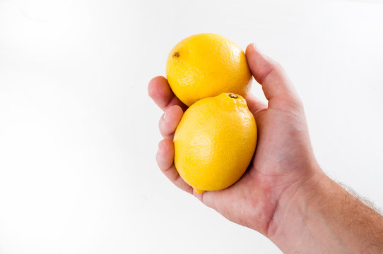 Two Fresh yellow lemon in hand of man