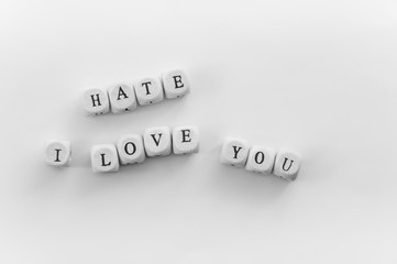 Word Hate spelled by dice above phrase I love you