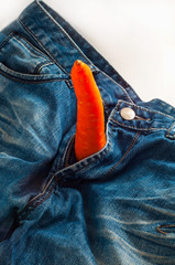 Carrot as symbol of Penis in jeans fly as concept of man health and strong