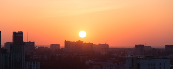 Voronezh city at sunset, against a colorful sky, panoramic aerial view from roof