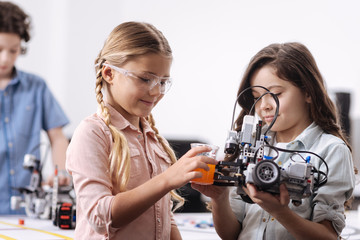 Inventive pupils conducting science experiment at school