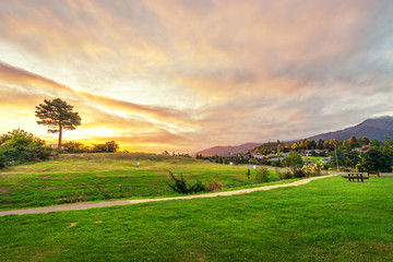 beautiful meadow near hill at sunset