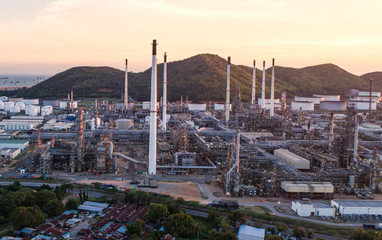 Aerial view Oil refinery with a background of mountains and sky.The factory is located in the middle of nature and no emissions. The area around the air pure.