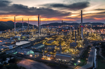 Aerial view Oil refinery with a background of mountains and sky.The factory is located in the middle of nature and no emissions. The area around the air pure.