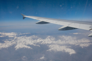 Fototapeta na wymiar Aerial view of snow covered alps through airplane, France