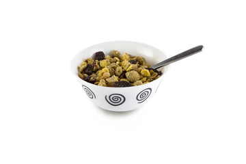 Bowl of muesli with dry fruits and spoon on white background