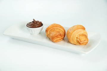 two fresh and tasty croissant over white background
