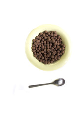 Cereal chocolate balls with bowl on white background