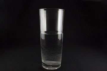 glass of water with bubbles on dark background
