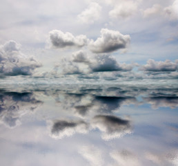 Fototapeta na wymiar Cloudy sky with reflection on water