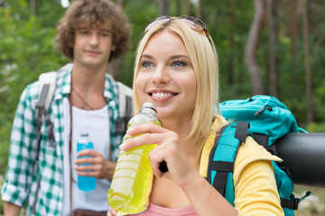 Hiking couple with energy drinks in forest