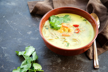 Spicy soup with coconut milk, noodles and shrimps. Eastern cuisine 