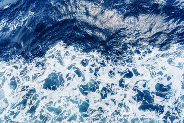 Atlantic ocean with blue water on a sunny day. Waves, foam and w