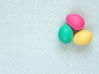Easter eggs on a green background with polka dots.