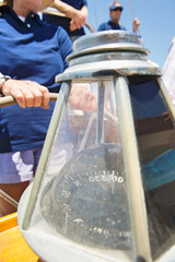 Close-up of compass on sailboat's helm