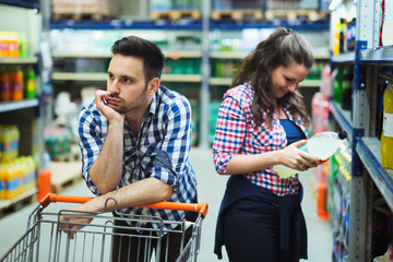 Husband bored while shopaholic woman enjoys