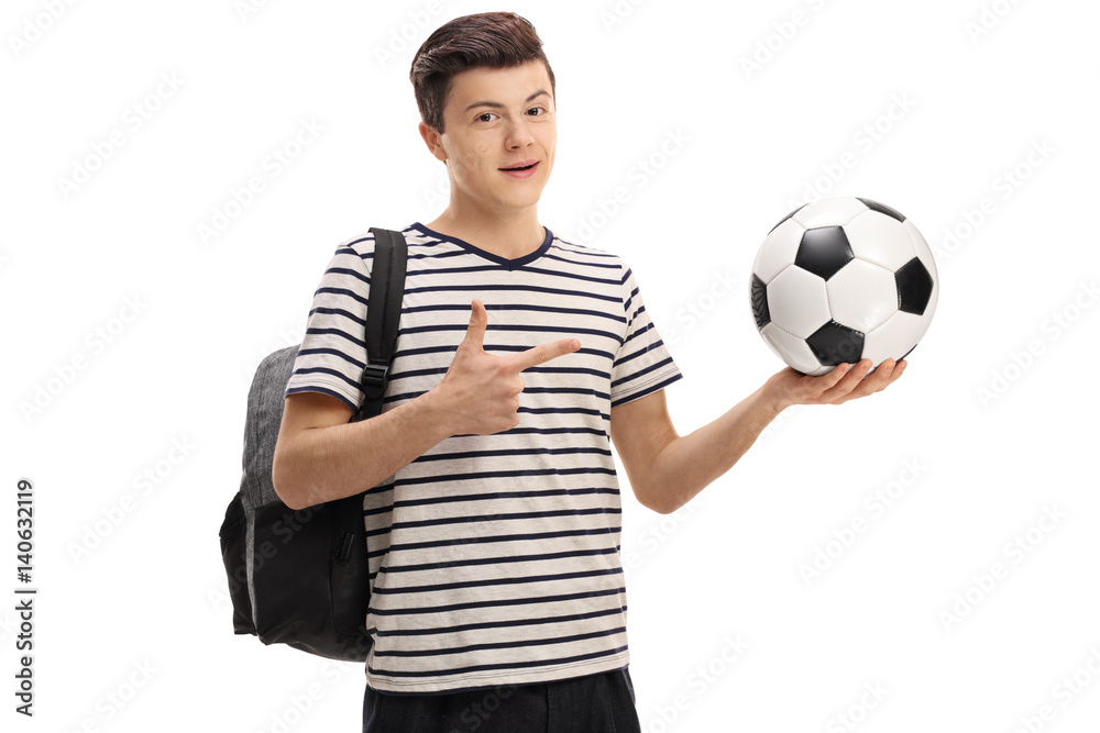 Wall mural teen student holding a football and pointing