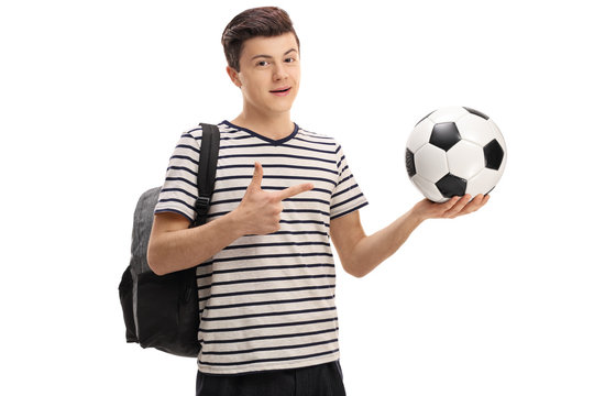 Teen student holding a football and pointing