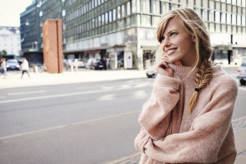 Beautiful woman in city, looking away