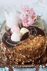 Holiday meal concept. Sweet chocolate cake with peanuts and shredded coconut flakes.