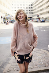 Beautiful woman in city, smiling at camera