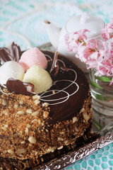 Holiday meal concept. Sweet chocolate cake with peanuts and shredded coconut flakes.