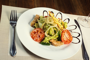 Warm salad with veal, pepper cabbage, tomatoes and onions with sesame and asparagus. Serving dishes in a restaurant, European cuisine, European restaurant, pub