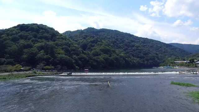 green mountain and blue river in summer time at Kyoto, Japan