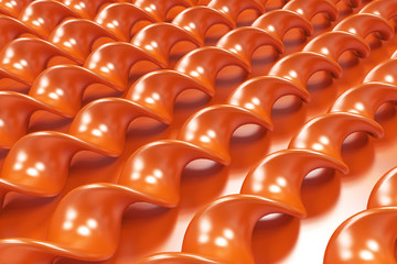 Obraz premium Orange plastic spiral sticks on orange background