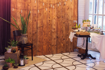 Obraz premium Zone for photo with sweet bar,greenery,retro bulbs,wooden background