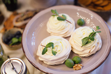 Meringues with mint  tray in the area  of the wedding banquet.Rustic candy-bar
