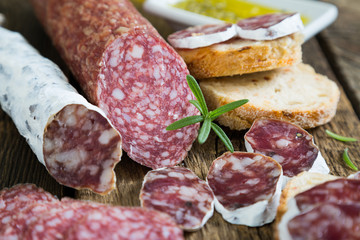 Salami variety, bread and herbs