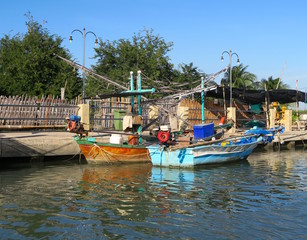 Fototapeta na wymiar Two traditional sailing boats on a canal, Thailand