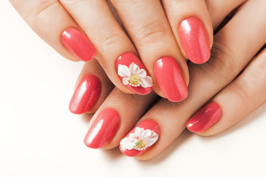 Red nails and floral deign.