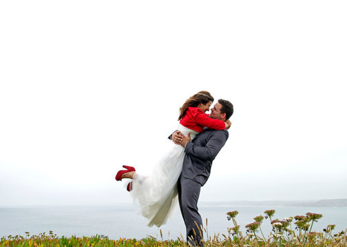 Groom embrassing the bride on the air