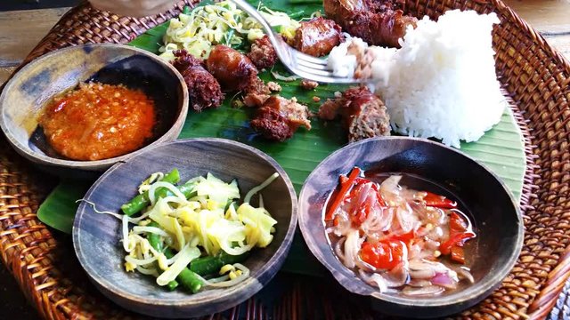 Eating of Urutan Banjar - pork sausage - tradition Balinese dish