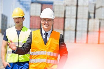 Male workers walking in shipping yard