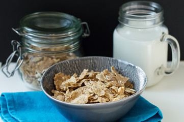 Bowl with crispy breakfast flakes with oats and milk. Healthy eating concept