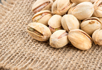 Salted pistachio nuts on burlap close up