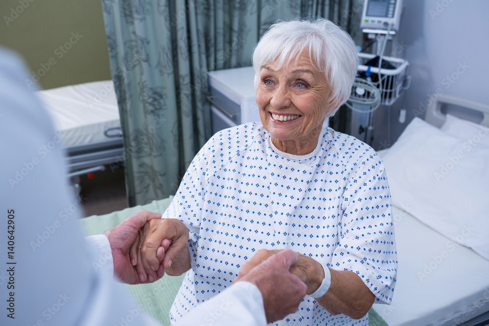 Wall mural Senior patient taking assistance from the doctor