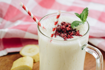 Pineapple banana milkshake with raspberry topping