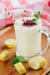 Pineapple banana milkshake with raspberry topping