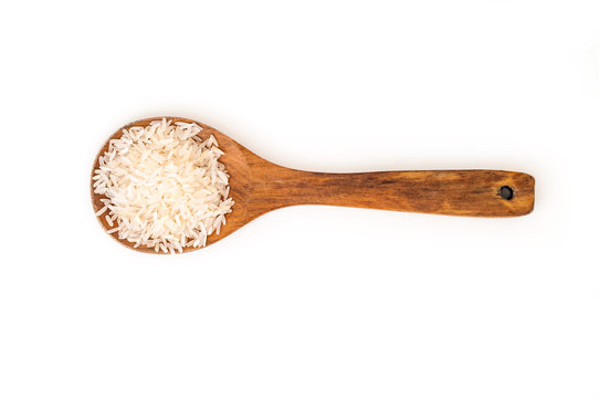 Heap of Jasmine white raw rice on wooden spoon