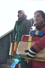 Men with gift boxes and shopping bags standing on steps