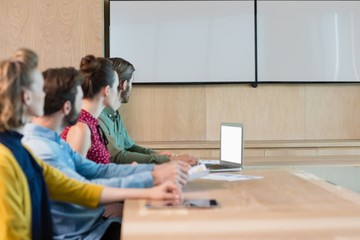 Business executives listening to a presentation