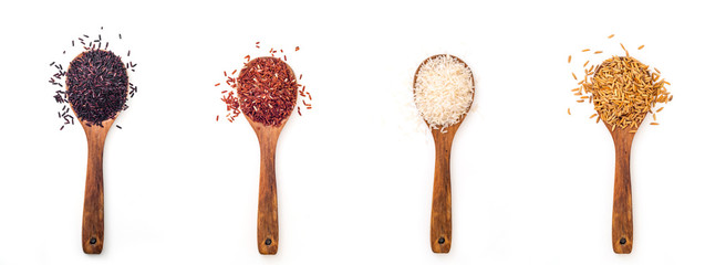For different kind of raw rice in wooden spoon on white background