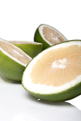 Green grapefruits on white background