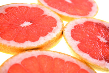Closeup of sliced grapefruit on white background