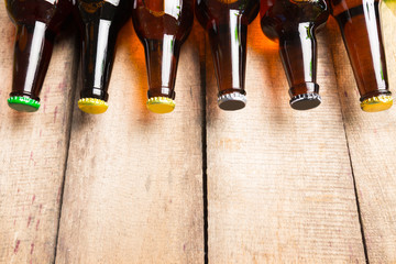 Beer bottles on a wooden table .