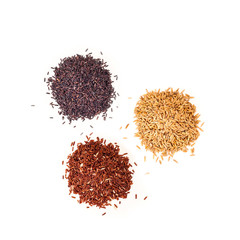 Three different kind of rice. Three heap of Black, Brown and unpolished raw rice on white background